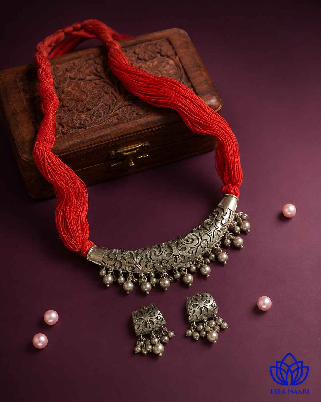 Brass construction supports the thread detailing of this necklace.