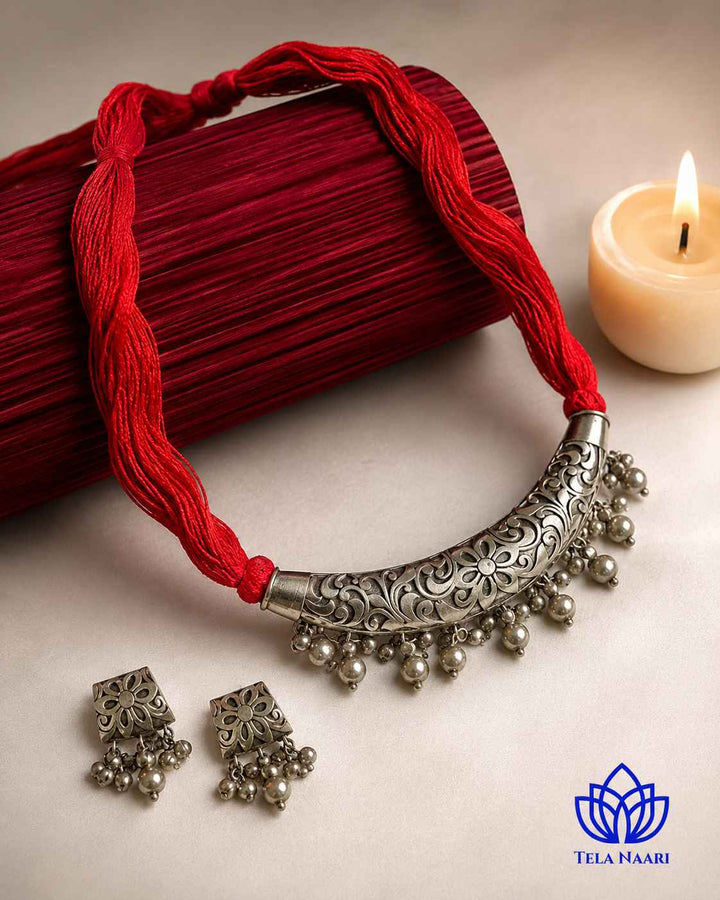 Textured thread work decorates the surface of this necklace.
