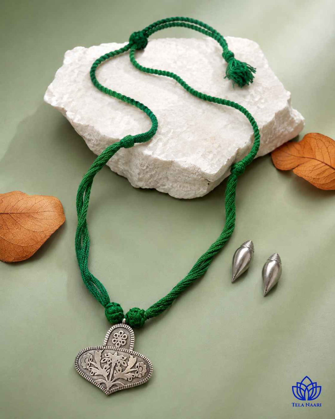 Matching earrings complete this green thread necklace set.