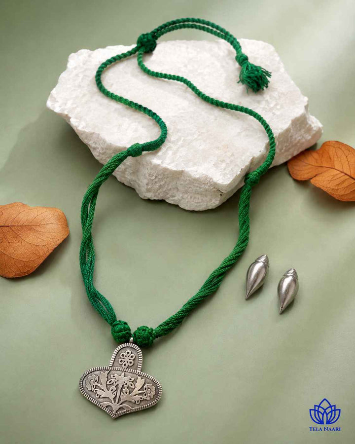 Matching earrings complete this green thread necklace set.