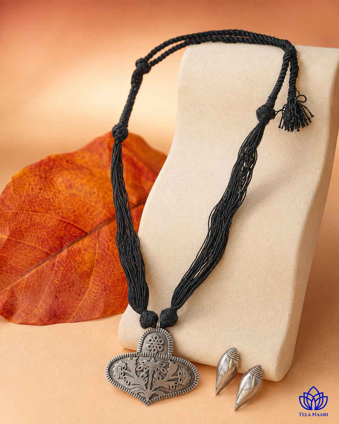Matching earrings complete this black thread necklace set.