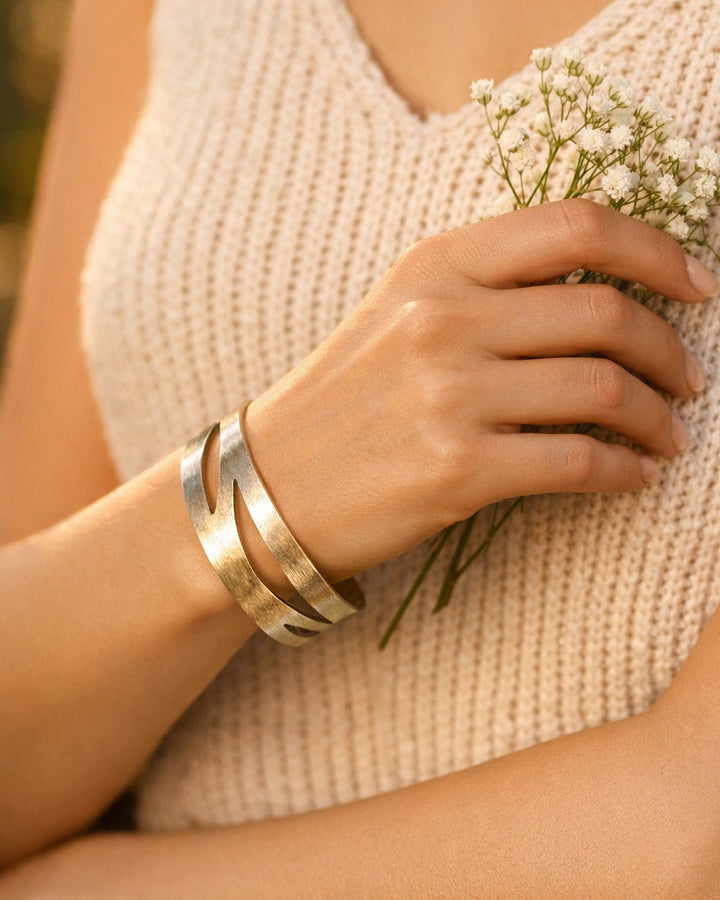 Brass construction supports the cut-out pattern of this cuff.