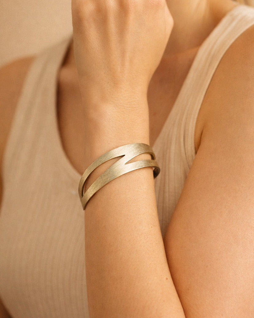 Open design lets this cut-out cuff bracelet fit most wrist sizes.