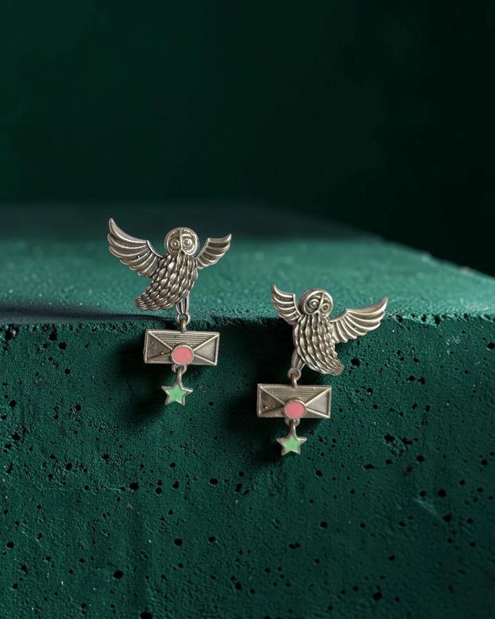 Brass construction supports the oxidised silver owl design.