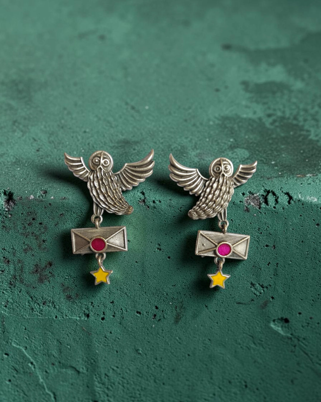 Dual-tone oxidised finish covers the surface of this owl earring.