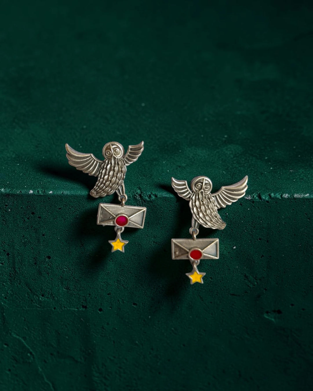 Handcrafted owl motif shapes the silhouette of this red earring.