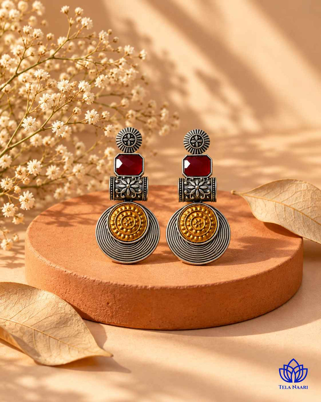 Metallic contrast defines the two-tone finish of this earring.