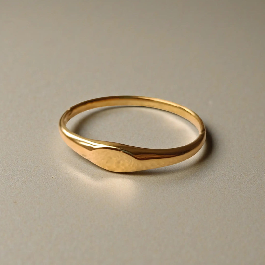 Sleek wave pattern defines the silhouette of this gold cuff.