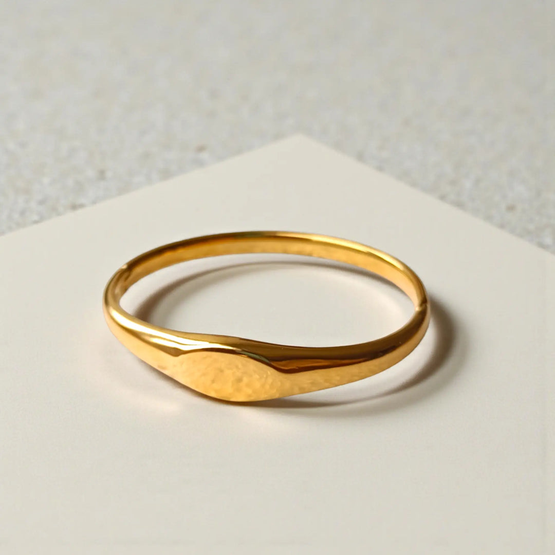 Minimalist wave detailing shapes the sleek silhouette of this cuff.