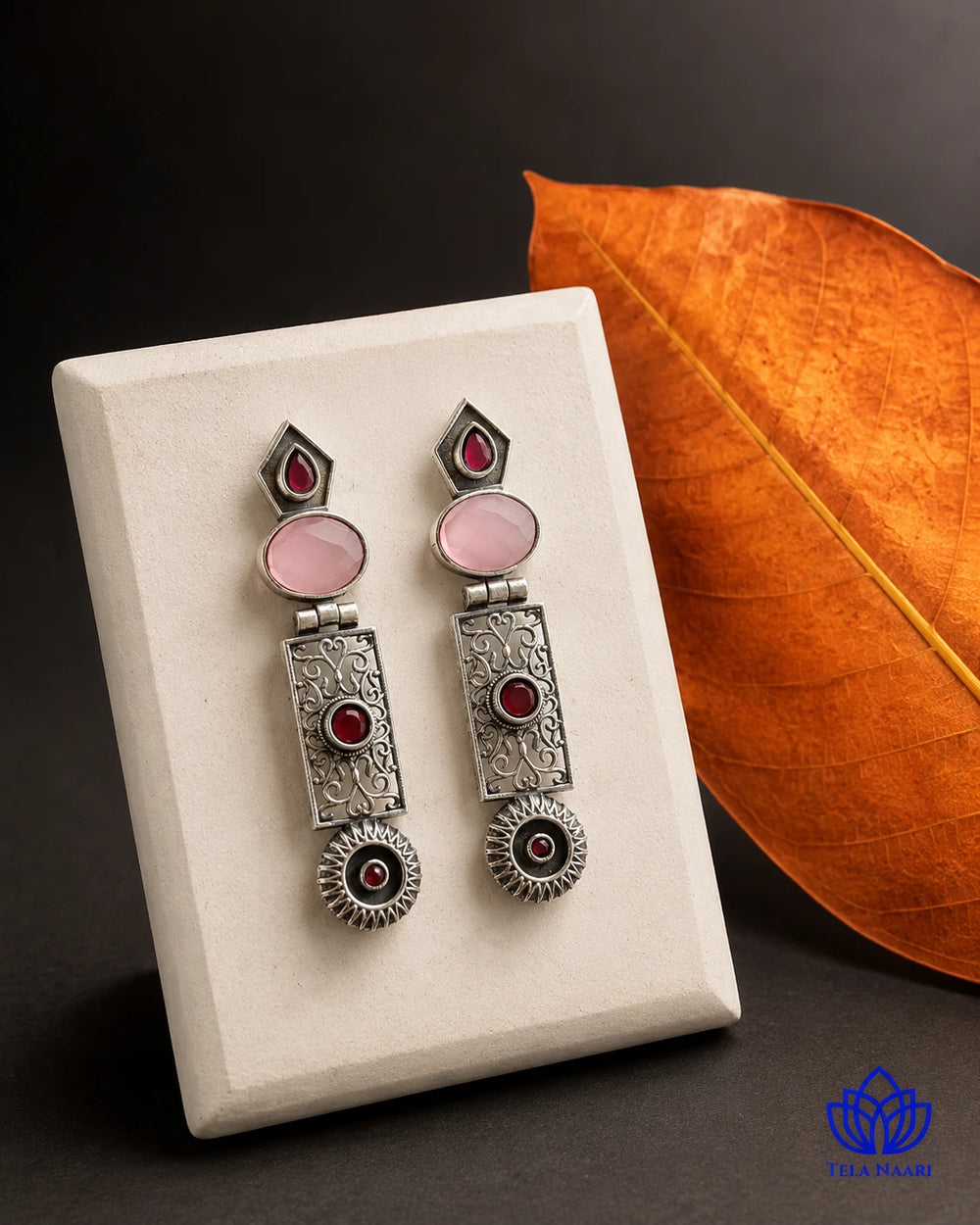 Oxidised silver-plated alloy covers the surface of this earring.