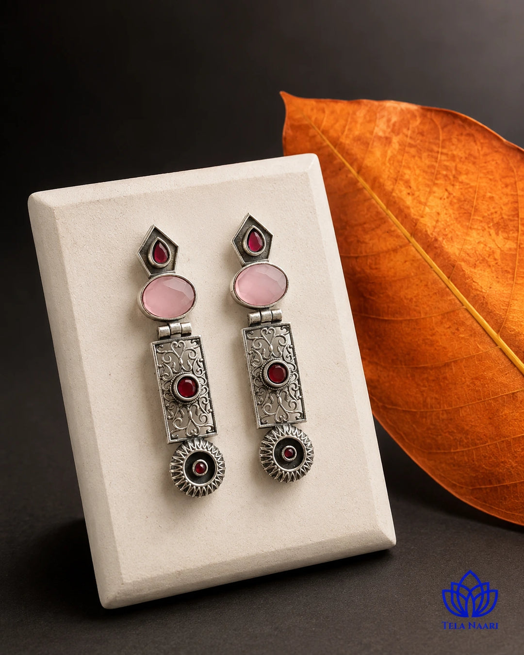 Oxidised silver-plated alloy covers the surface of this earring.