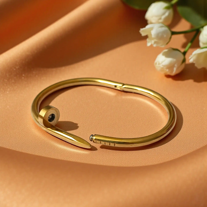 Sleek stainless steel base supports the nail-head pattern on this cuff.