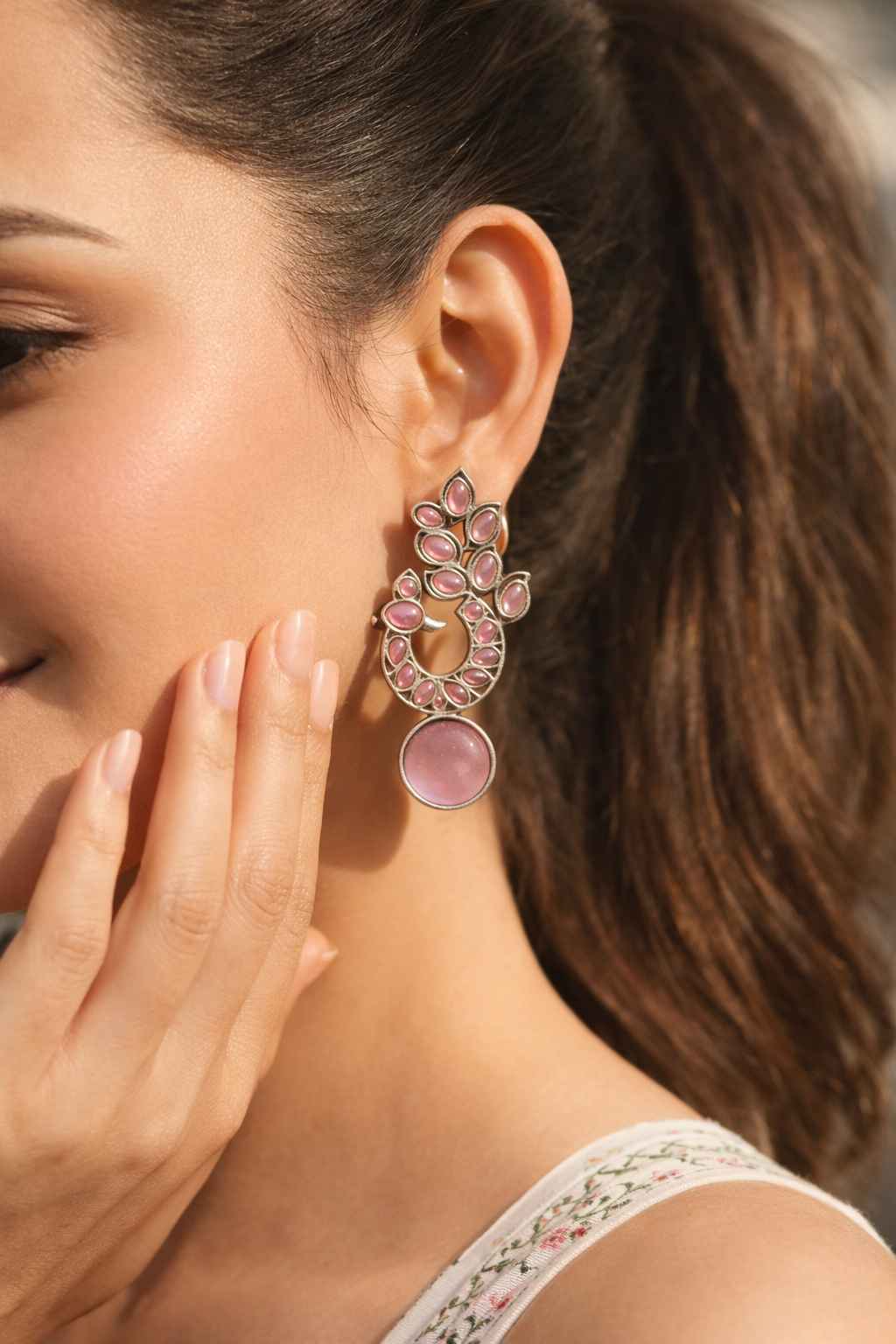 Traditional oxidised patterns shape the silhouette of this earring.