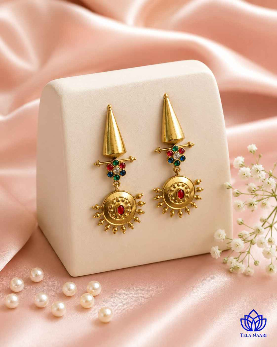 Brass construction forms the structure of this dangler earring shape.