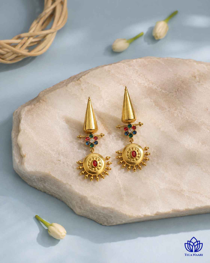 Contemporary silhouette pairs dual-tone plating with a dangle design.