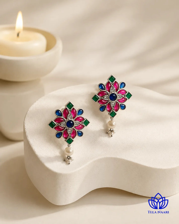 Brass construction supports the floral design of this stud earring.