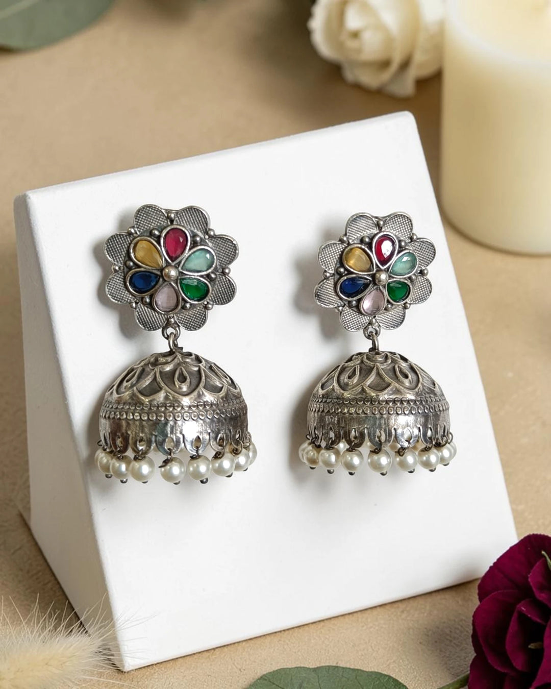Darkened oxidised finish gives this bell-shaped jhumka its antique look.