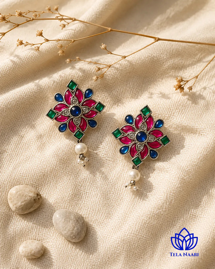 Lustrous pearl centre sits at the heart of this floral stud.