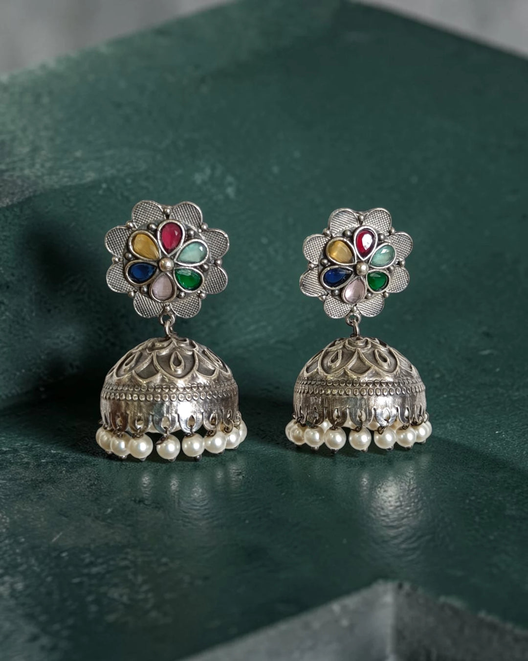 Silver oxidised surface covers the traditional bell shape of this earring.