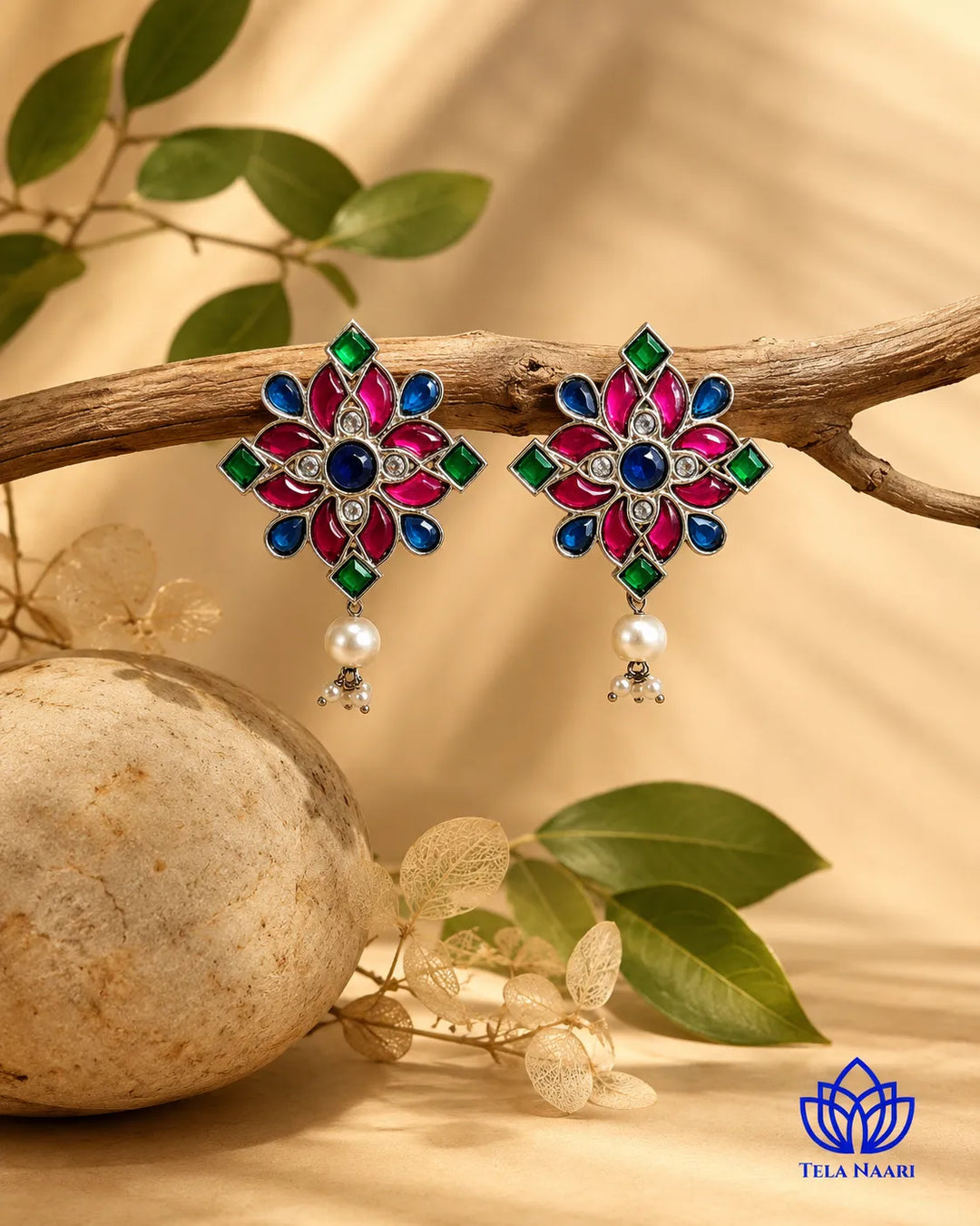 Textured brass surface supports the floral pearl earring design.