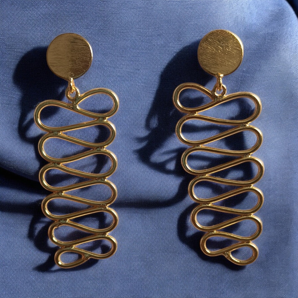 Antique gold finish covers the surface of this spiral earring.