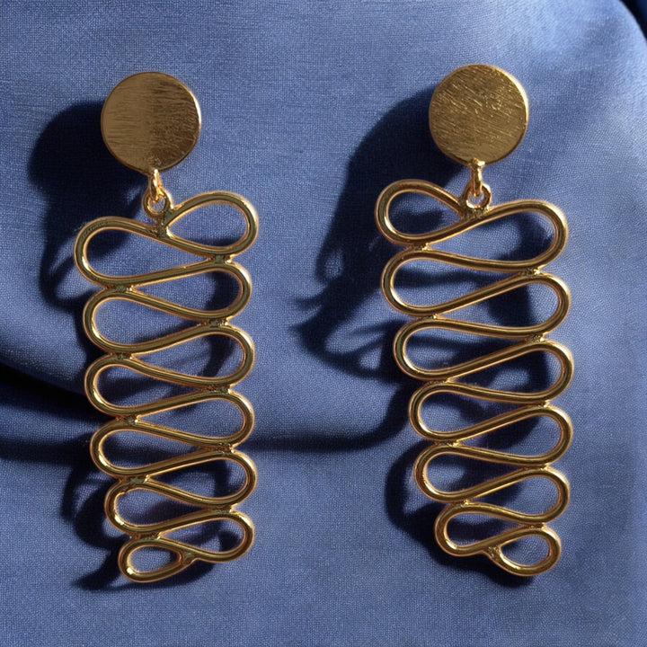 Antique gold finish covers the surface of this spiral earring.