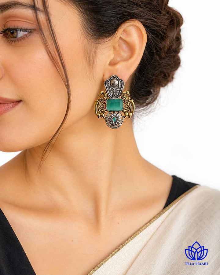 Fusion-forward sea green tones shape the silhouette of this earring.