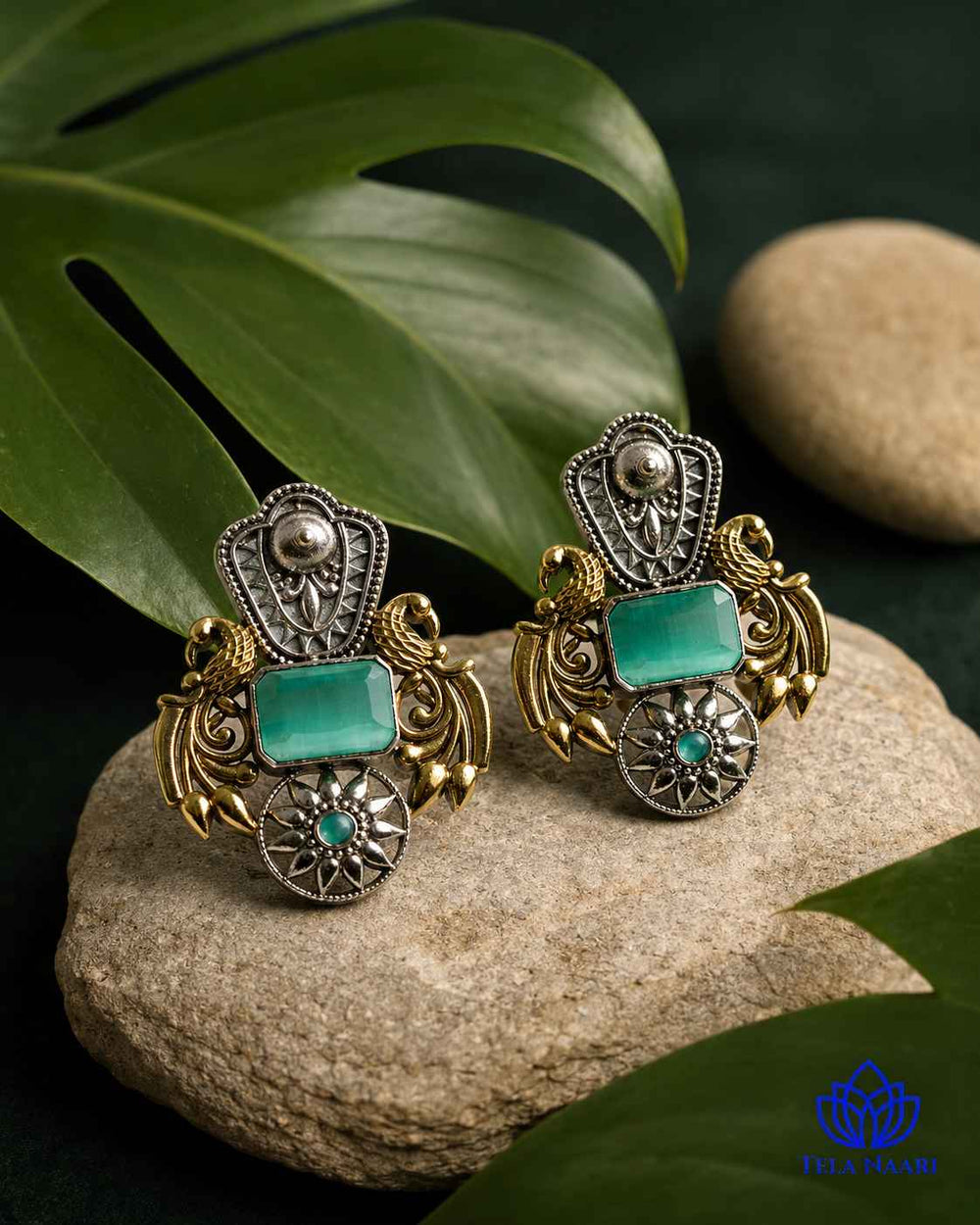 Silver oxidised finish covers half of this dual-tone earring.