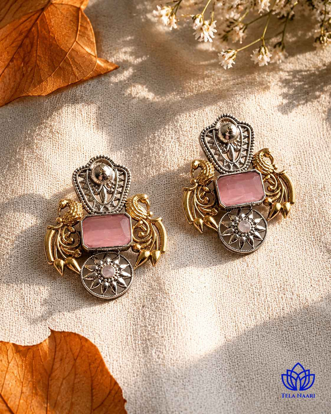 Bold pink accents highlight the dual-tone plating on this earring.