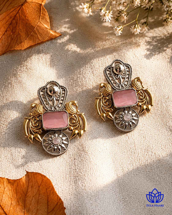 Bold pink accents highlight the dual-tone plating on this earring.