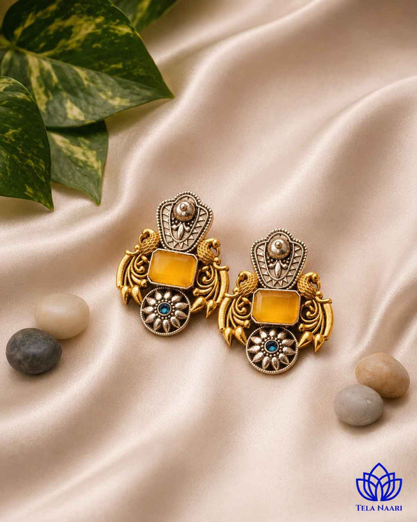 Traditional craftsmanship shines through this bold dual-tone silver oxidised earring.