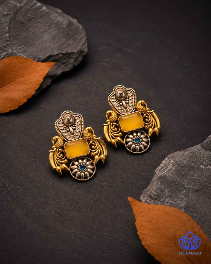 Bold dual-tone plating covers the surface of this statement earring.