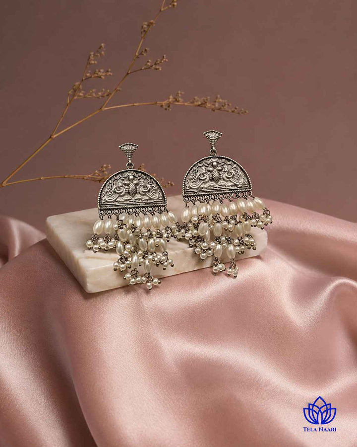 Brass construction forms the base beneath the white bead detailing.