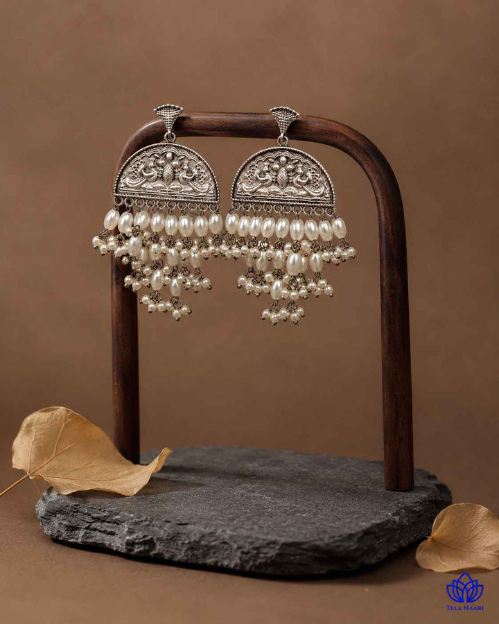 Delicate craftsmanship defines the texture of this beaded earring.