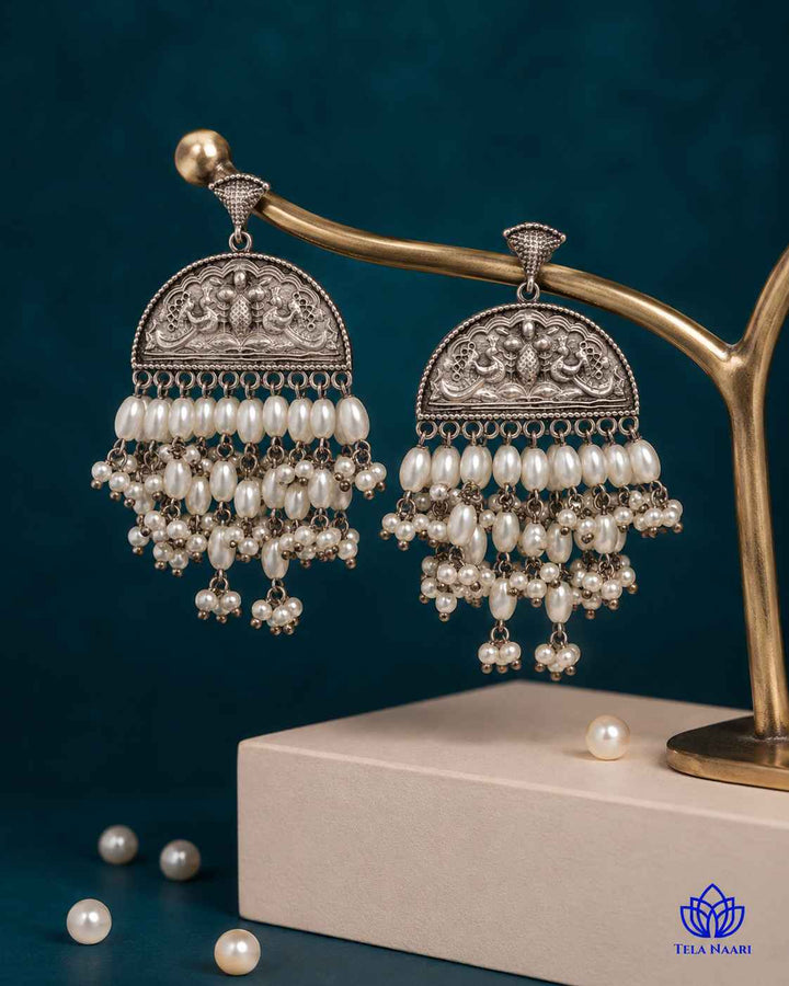 Handcrafted beadwork decorates the surface of this silver-plated earring.