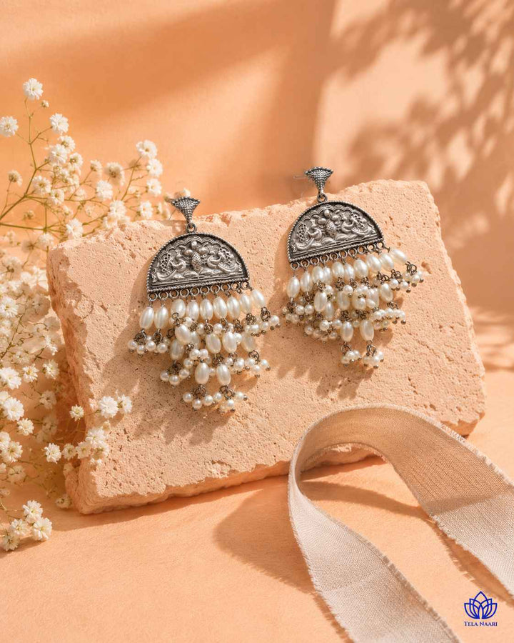 Polished surface highlights the intricate white bead detailing.