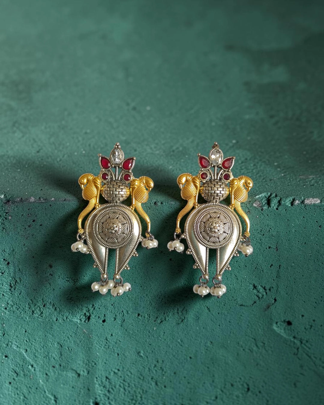 Oxidised and polished finishes create bold contrast on this red earring.