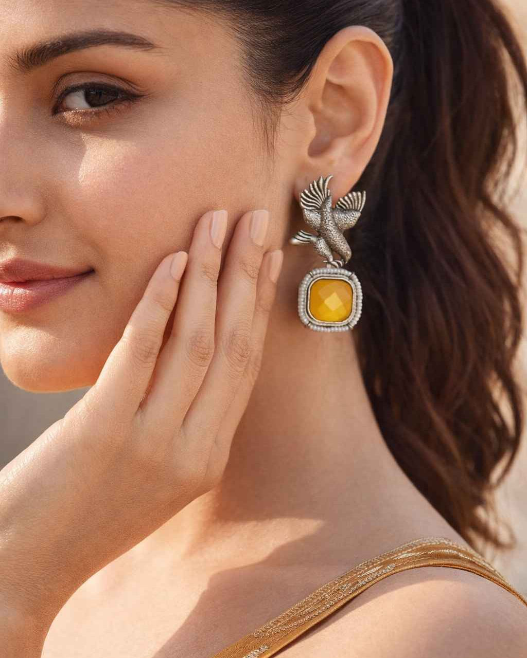 Bird motif detailing shapes the silhouette of this silver-plated earring.
