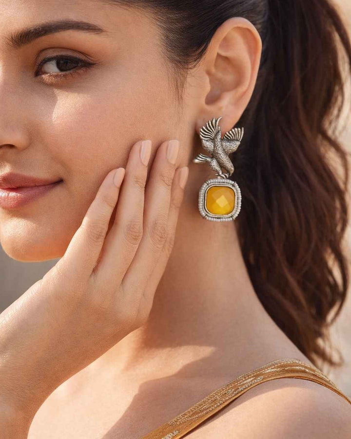 Bird motif detailing shapes the silhouette of this silver-plated earring.