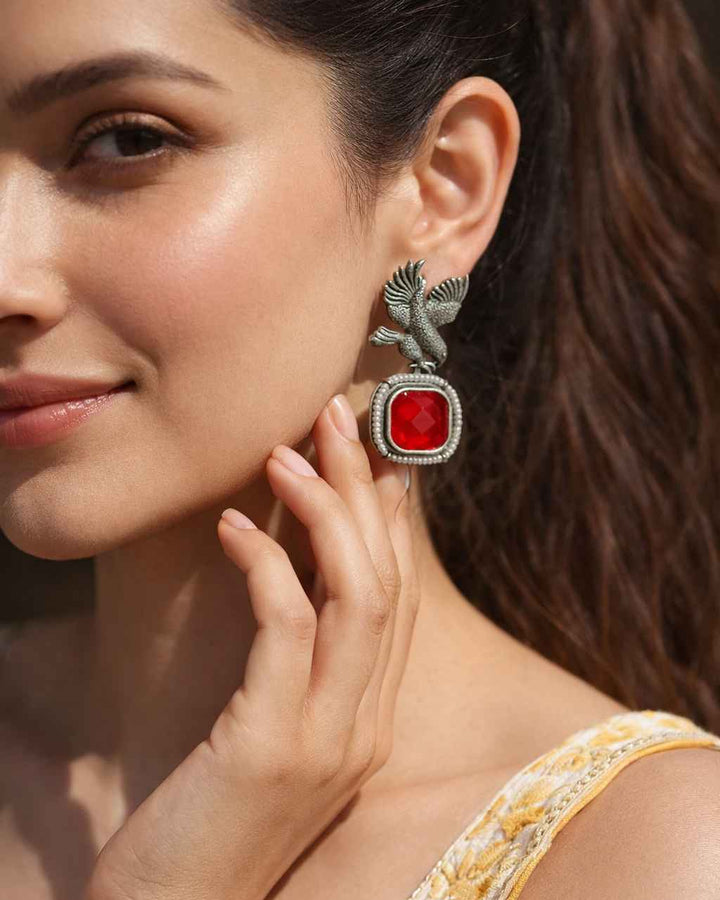 Brass construction supports the avian silhouette of this earring.