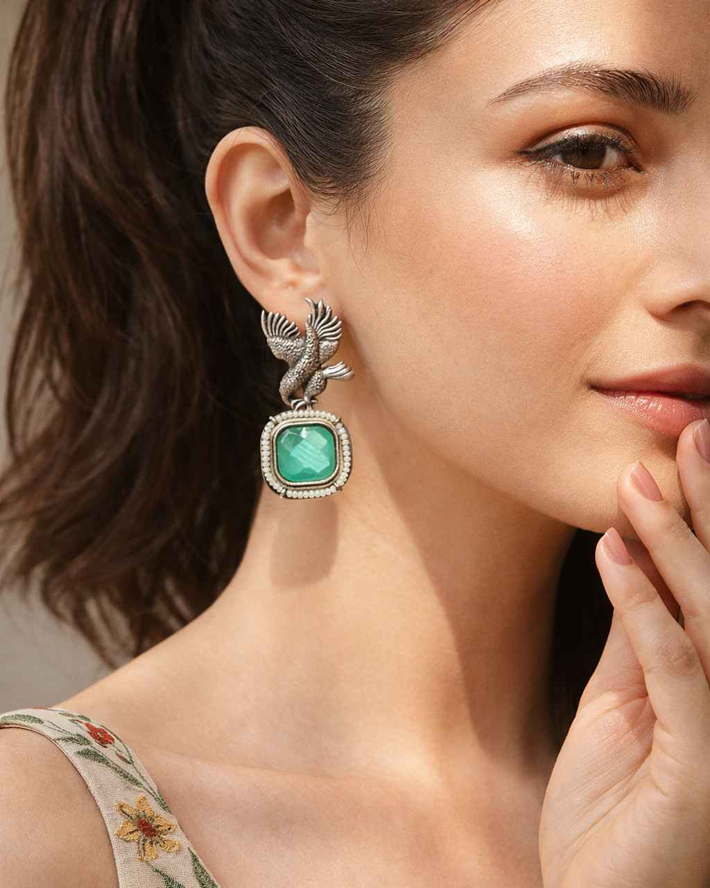 Classic avian motif defines the silhouette of this silver-plated earring.