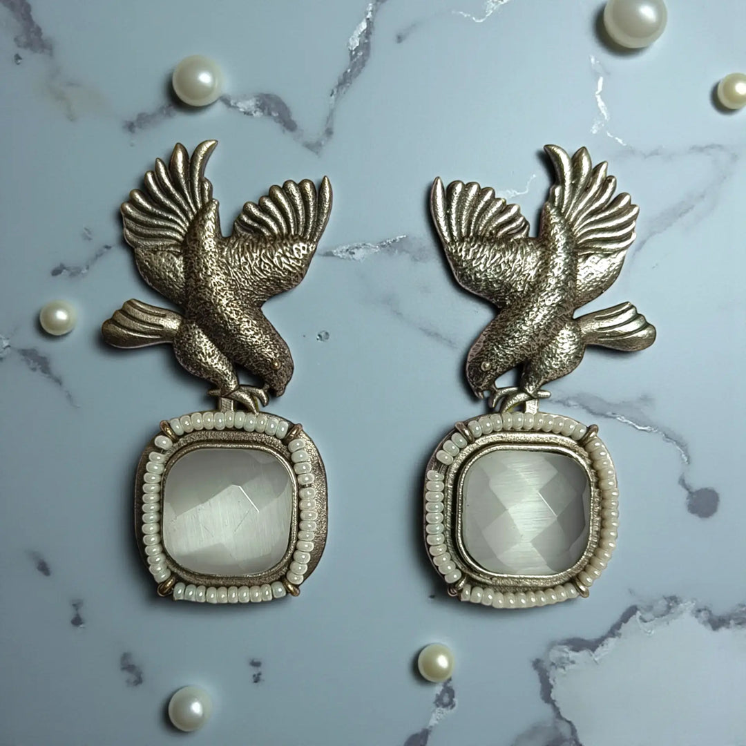 Post and back closure secures this silver-plated bird motif earring.