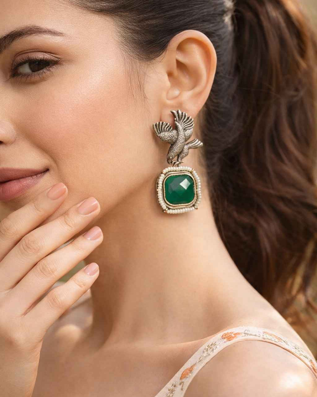 Silver-plated finish covers the surface of this bird motif earring.