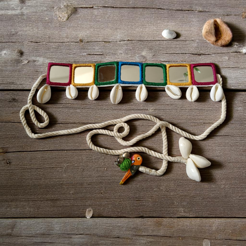 Natural cowrie shells decorate the surface of this fabric choker.
