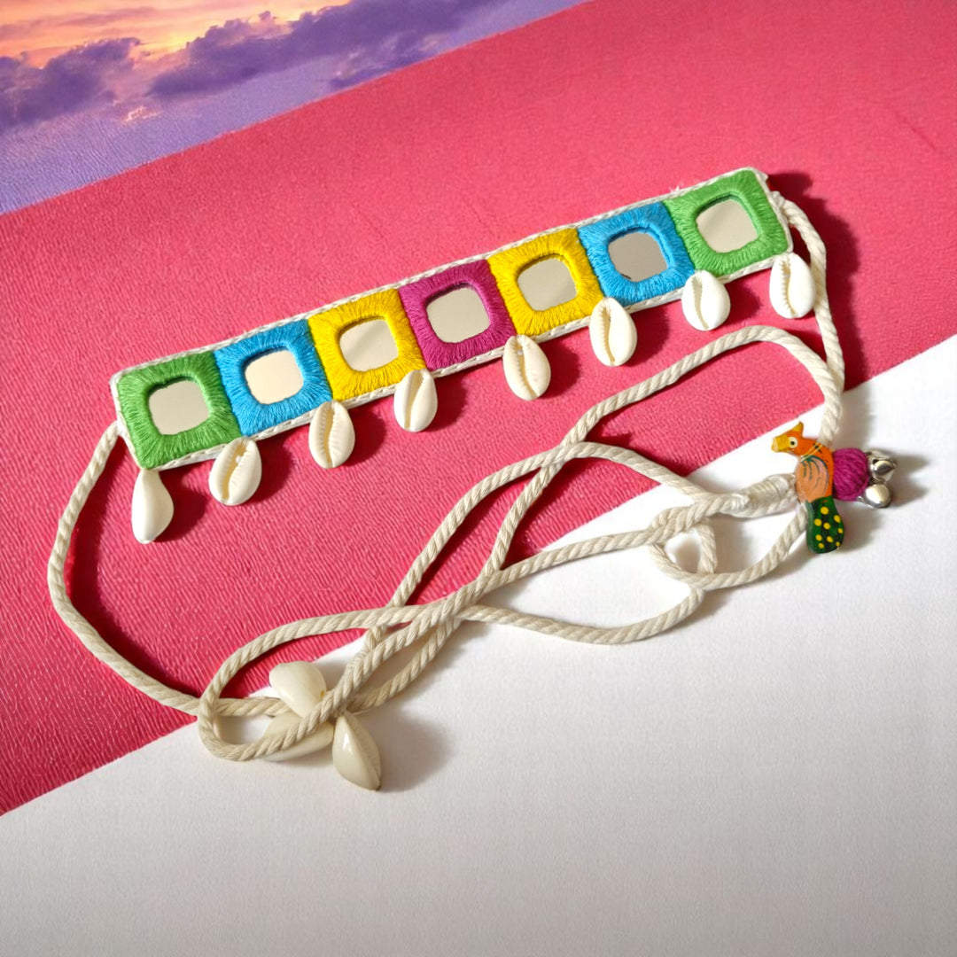 Mirror embellishments catch the light across this pastel choker.
