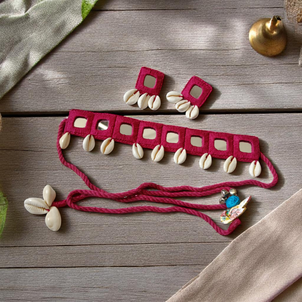 Shell embellishments decorate the surface of this pink fabric choker.