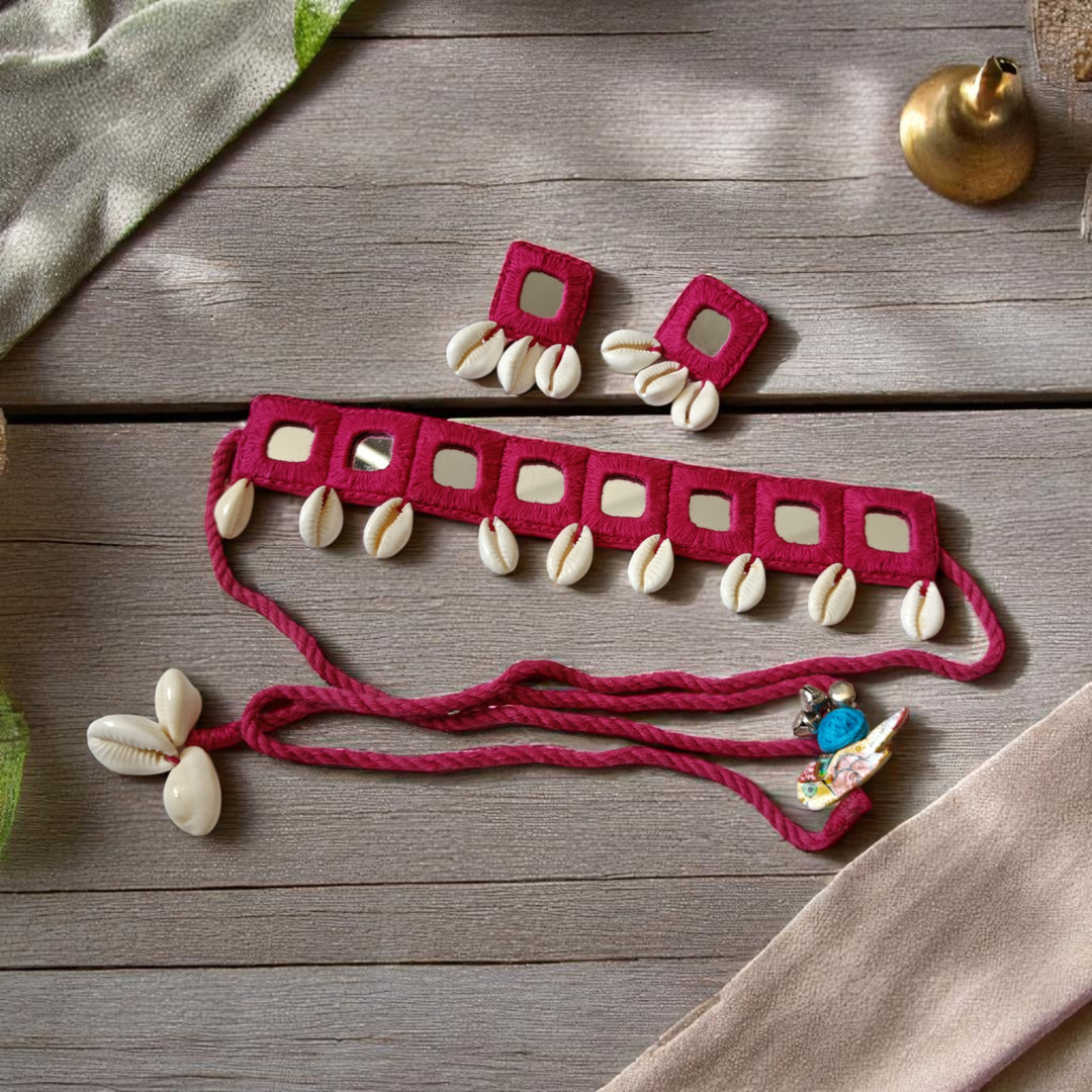 Shell embellishments decorate the surface of this pink fabric choker.