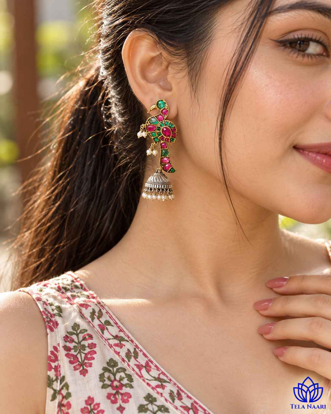 Post and back closure secures this dual-tone jhumka earring.
