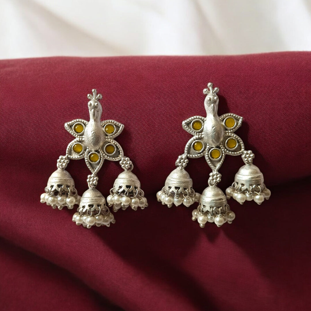 Pink accent brings colour to this silver-plated peacock earring.