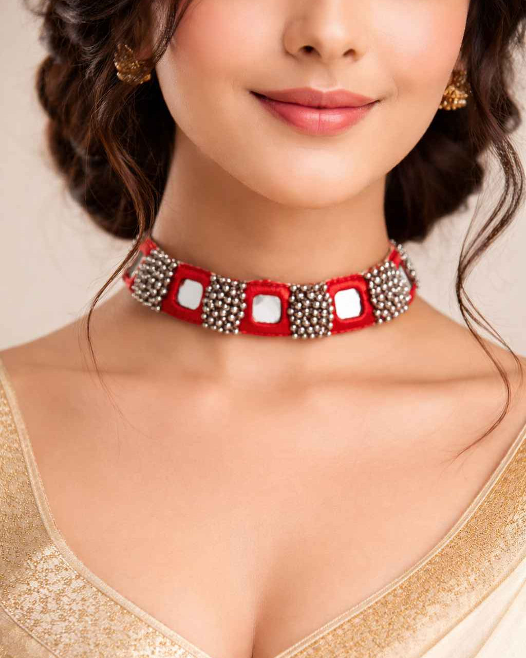 Dazzling silver beads decorate the surface of this red choker.